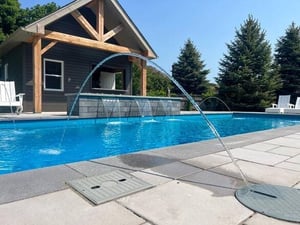 Dolphin fiberglass pool with water feature in Kitchener