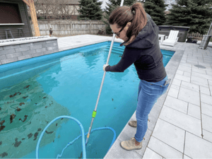 Pool Service Tech Vacuuming Pool