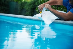 Maintaining a salt water pool by dumping pool salt into the swimming pool